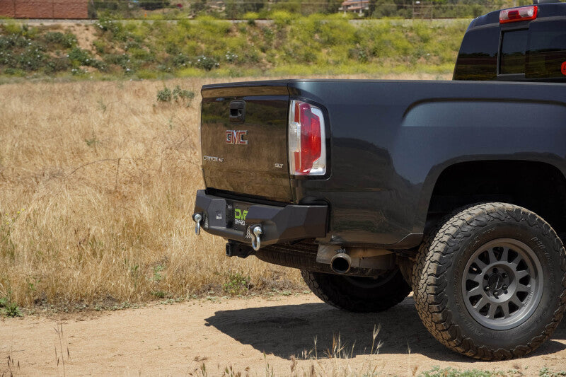 Steel rear bumper for Chevy Colorado and GMC Canyon from DV8 Offroad MTO Series, rugged off-road vehicle bumper.