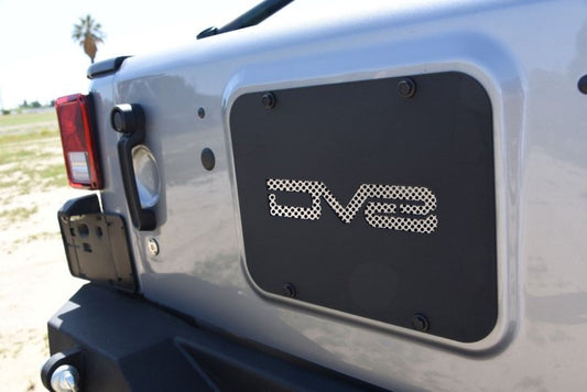 DV8 Offroad Jeep Wrangler tailgate tramp stamp accessory mounted on the tailgate of a 2007-2018 Jeep Wrangler.