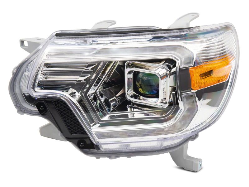 Raxiom 12-15 Toyota Tacoma Axial Series switchback projector headlights with chrome housing and clear lens for enhanced visibility.