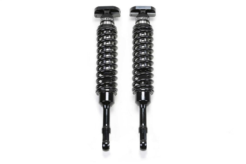 Pair of Fabtech Ford F150 4WD dirt logic 2.5 coilovers with black shock bodies and mounting hardware for front suspension upgrade.