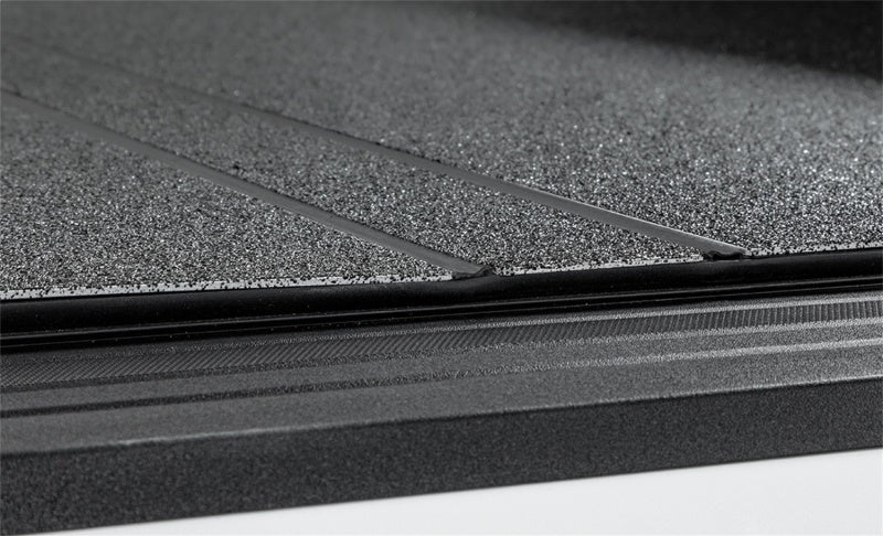 Access LOMAX tri-fold truck bed cover in black urethane finish on a 19+ Chevrolet Silverado 1500 with 6ft 6in bed.