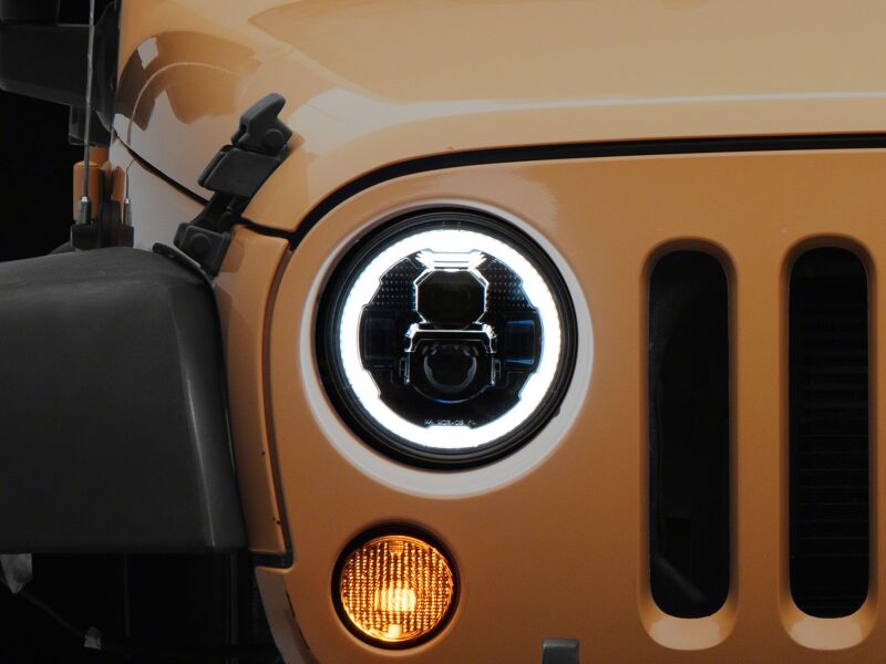 Raxiom 07-18 Jeep Wrangler LED headlights with black housing and clear lens, featuring DRL and 7-inch size.