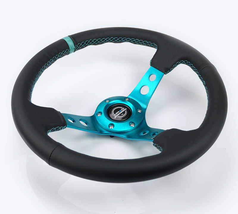 NRG Reinforce 350mm black leather steering wheel with teal center mark and teal stitching for sporty car interior.