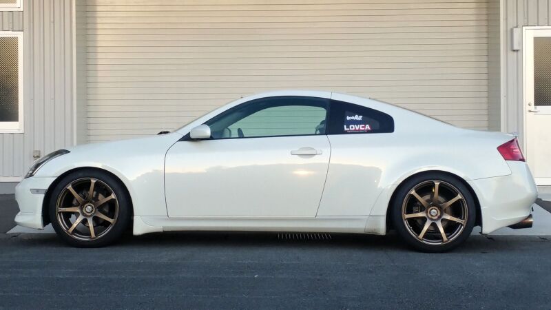 HKS HIPERMAX S coilover suspension kit installed on a Nissan Z33 sports car, showing the adjustable shock absorbers and suspension components.
