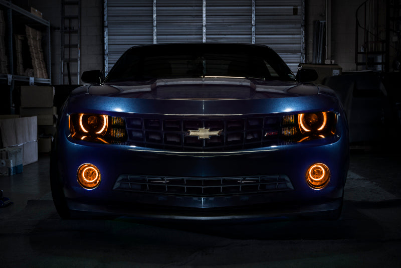 Oracle Chevrolet Camaro LED fog light halo kit with amber rings, designed for 2010-2013 models, enhancing visibility and style.