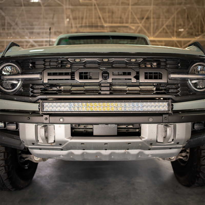Cali Raised LED Ford Raptor bumper light bar mounting kit with 5D Optic Osram 32-inch dual-row spot light bar installed on the bumper