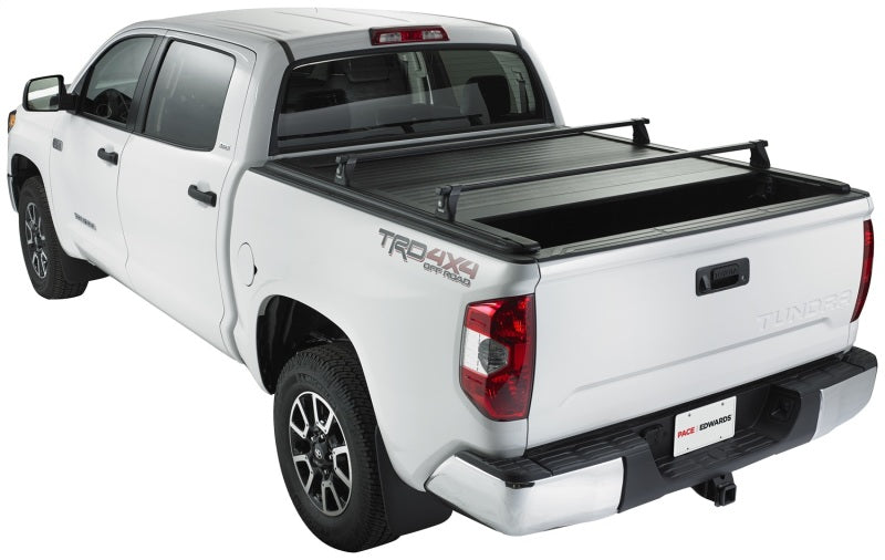 Pace Edwards Ultragroove retractable tonneau cover on a Nissan Titan King Cab pickup truck bed, showcasing sleek design and secure fit.