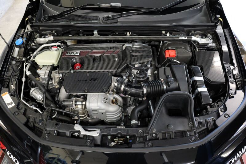 HKS dry carbon fuse box cover for FL5, lightweight carbon accessories, sleek black finish, high-quality automotive protection.