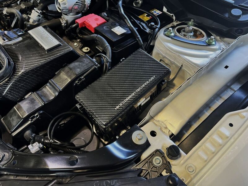 HKS dry carbon fuse box cover for FK8, precision-crafted carbon accessory with sleek black finish for Honda Civic Type R.