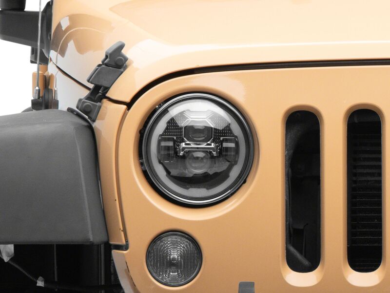 Raxiom 07-18 Jeep Wrangler Axial Series 7-inch LED headlights with black housing and clear lenses, featuring DRL functionality.