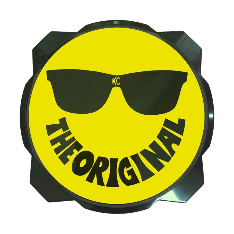 Yellow and black KC HiLiTES smiley face 6-inch hard cover for Gravity Pro6 LED lights, featuring KC logo and protective design.