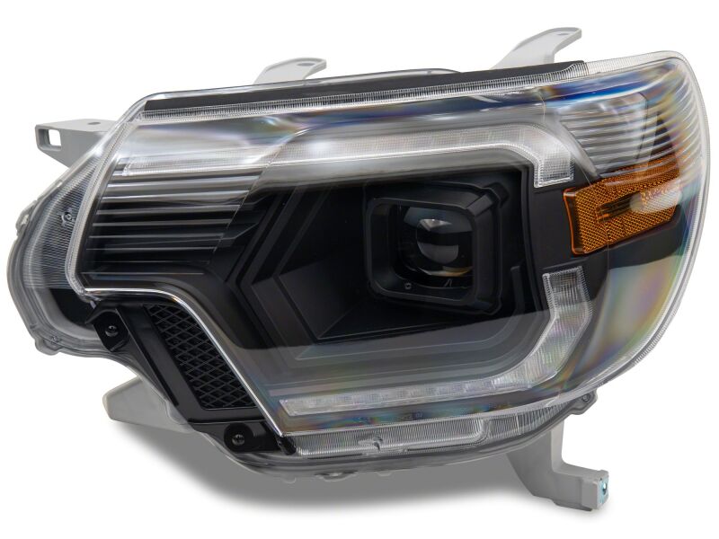 Black housing Raxiom 12-15 Toyota Tacoma Axial Series switchback projector headlights with clear lenses.