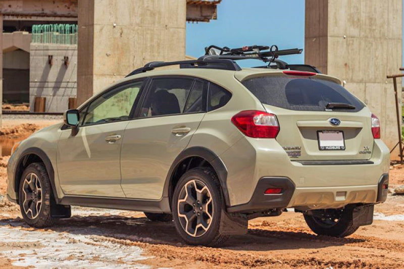 Rally Armor black mud flaps with orange logo on a 2013-2017 Subaru Crosstrek XV, showing the durable protective design.