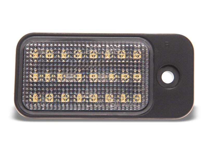 Raxiom 19-23 Jeep Cherokee KL Axial Series LED license plate bulbs installed on the vehicle, illuminating the license plate area.