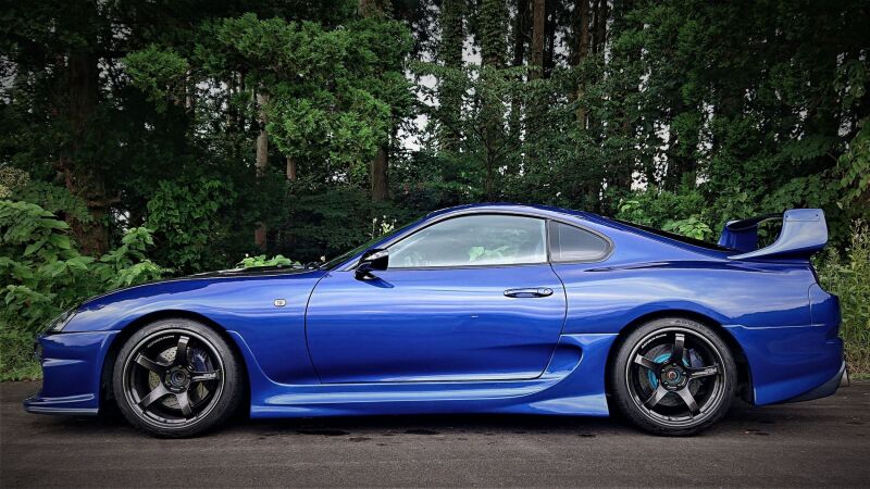 HKS HIPERMAX S coilover kit installed on a JZA80 Toyota Supra, showcasing adjustable suspension components and coilover shocks.