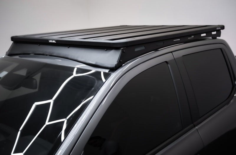Rival 4x4 aluminum roof rack for Ford Ranger 24-26 and Ranger Raptor, mounted on the vehicle's roof for added cargo capacity.