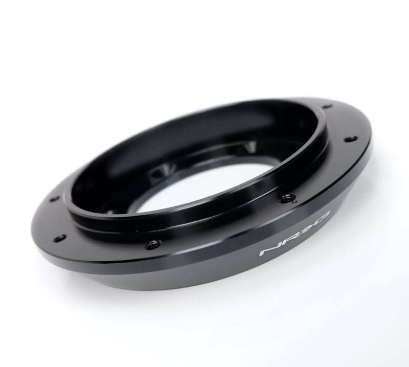 NRG 6 to 9 hole steering wheel hub adapter showing metallic finish and mounting points for car steering wheel installation.