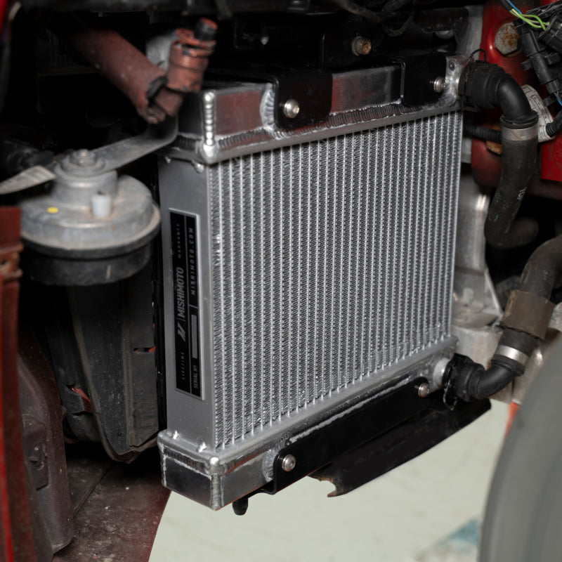 Mishimoto 15-20 BMW F80 F82 M3 M4 performance auxiliary radiator showing metal fins and mounting points.