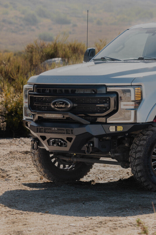 Steel front bumper for Ford Super Duty F-250/F-350, DV8 Offroad Spec Series, rugged and durable off-road vehicle bumper.