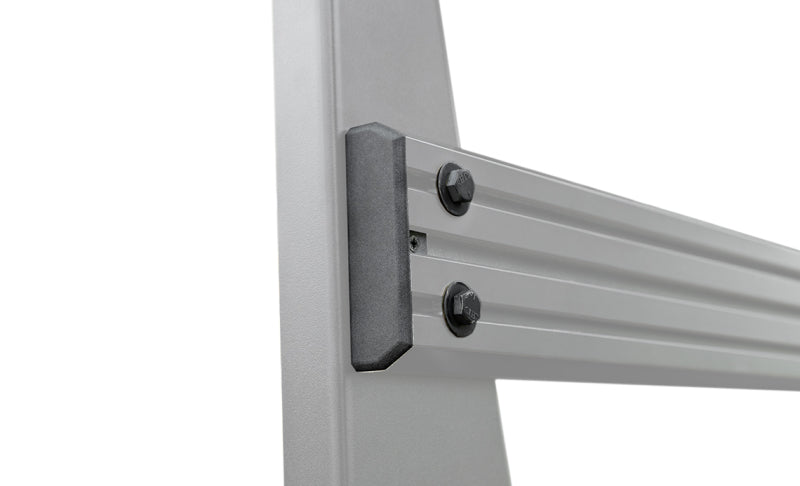 Set of four Access ADATRAC end caps for Aluminum Pro Series truck bed rack accessories, shown on the rack in a vehicle bed.