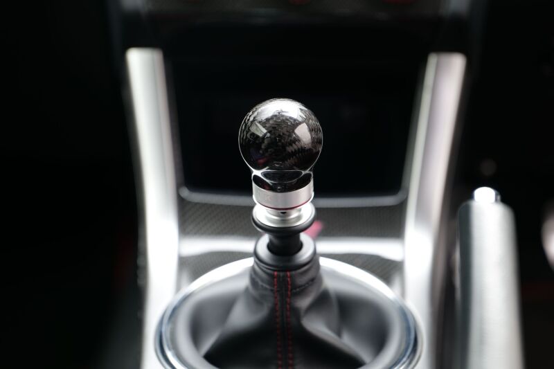 HKS carbon shift knob for 2015-2021 Subaru WRX STI 6-speed manual transmission, featuring a sleek black finish and textured grip