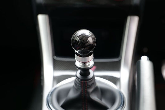HKS carbon shift knob for 2015-2021 Subaru WRX STI 6-speed manual transmission, featuring a sleek black finish and textured grip