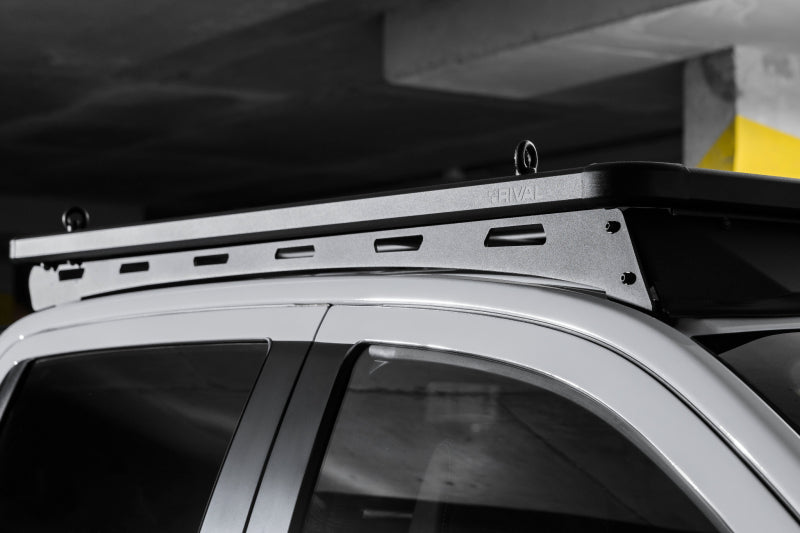 Rival 4x4 aluminum roof rack for Ford Ranger and Ranger Raptor, mounted on vehicle roof, providing durable cargo storage.