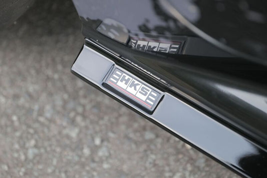 HKS Type-S GR Corolla side skirt body kit installed on a Toyota Corolla, showcasing sleek, aerodynamic design for enhanced sporty look.