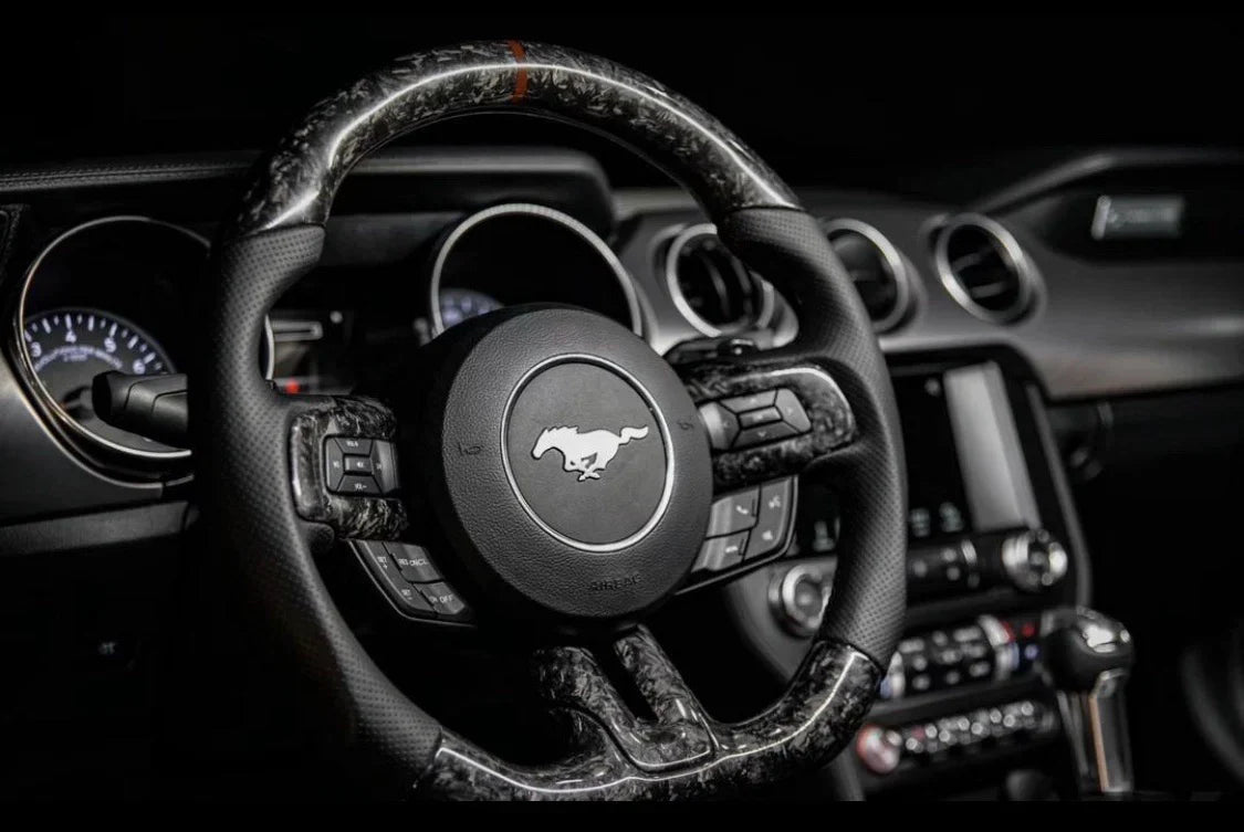 Custom carbon fiber steering wheel for Ford Mustang S550 (2015-2023) by Street Driven Performance, showing detailed craftsmanship and design.