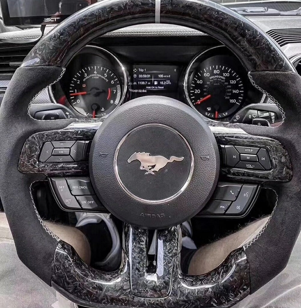 Custom carbon fiber Ford Mustang S550 steering wheel from Street Driven Performance, showcasing a sleek interior upgrade.