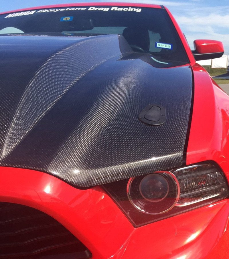 Anderson Composites carbon fiber cowl hood for 2013-2014 Ford Mustang, showcasing sleek design and lightweight construction.